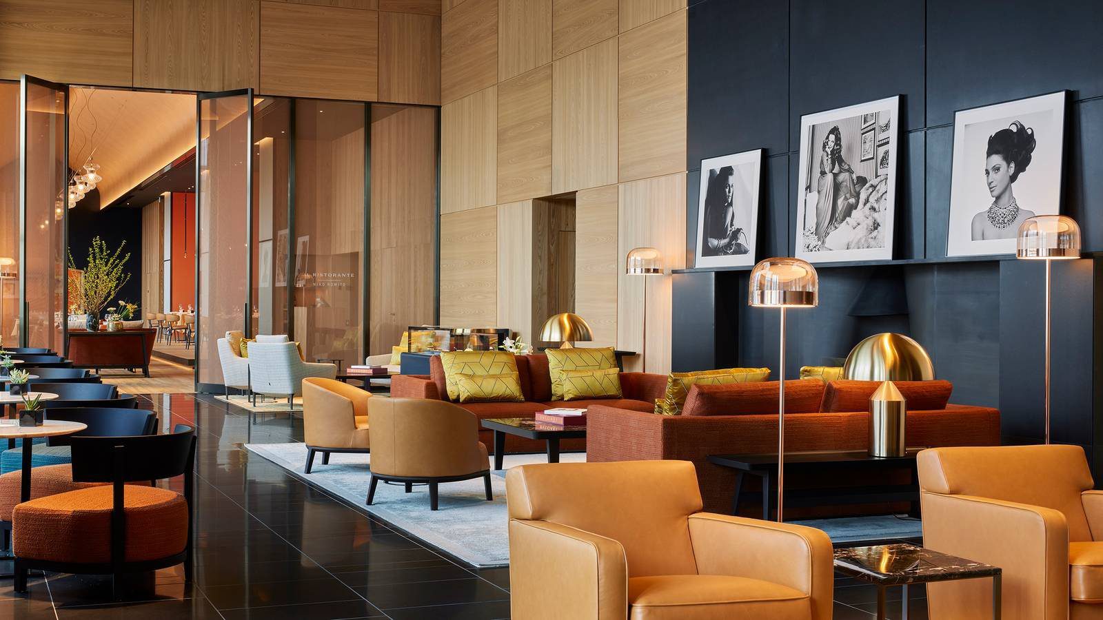 東京寶格麗酒店 The Bvlgari Lounge 的橘色沙發區與黑白肖像