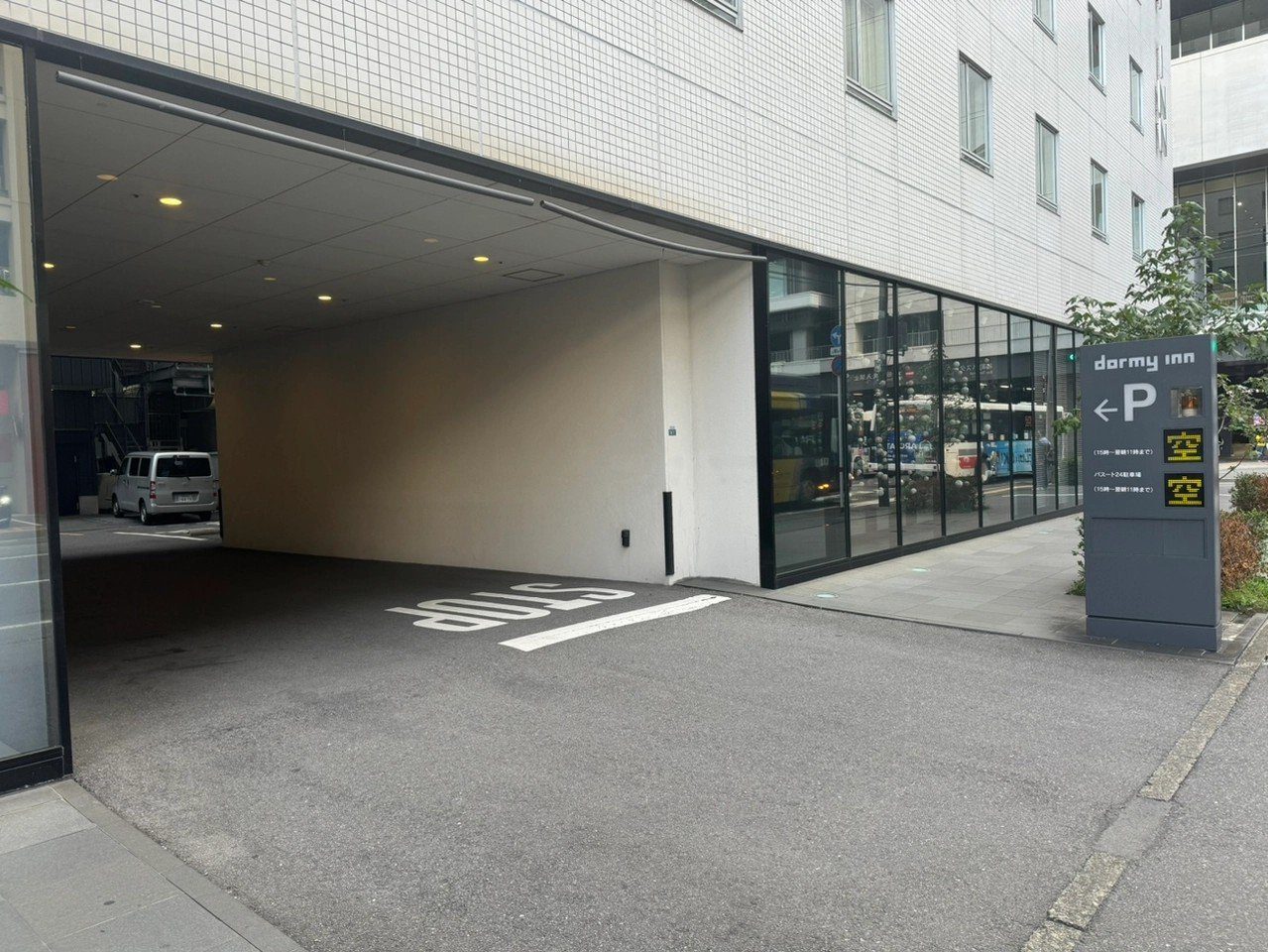Dormy Inn 熊本 掛著 P 標誌的館內停車場入口