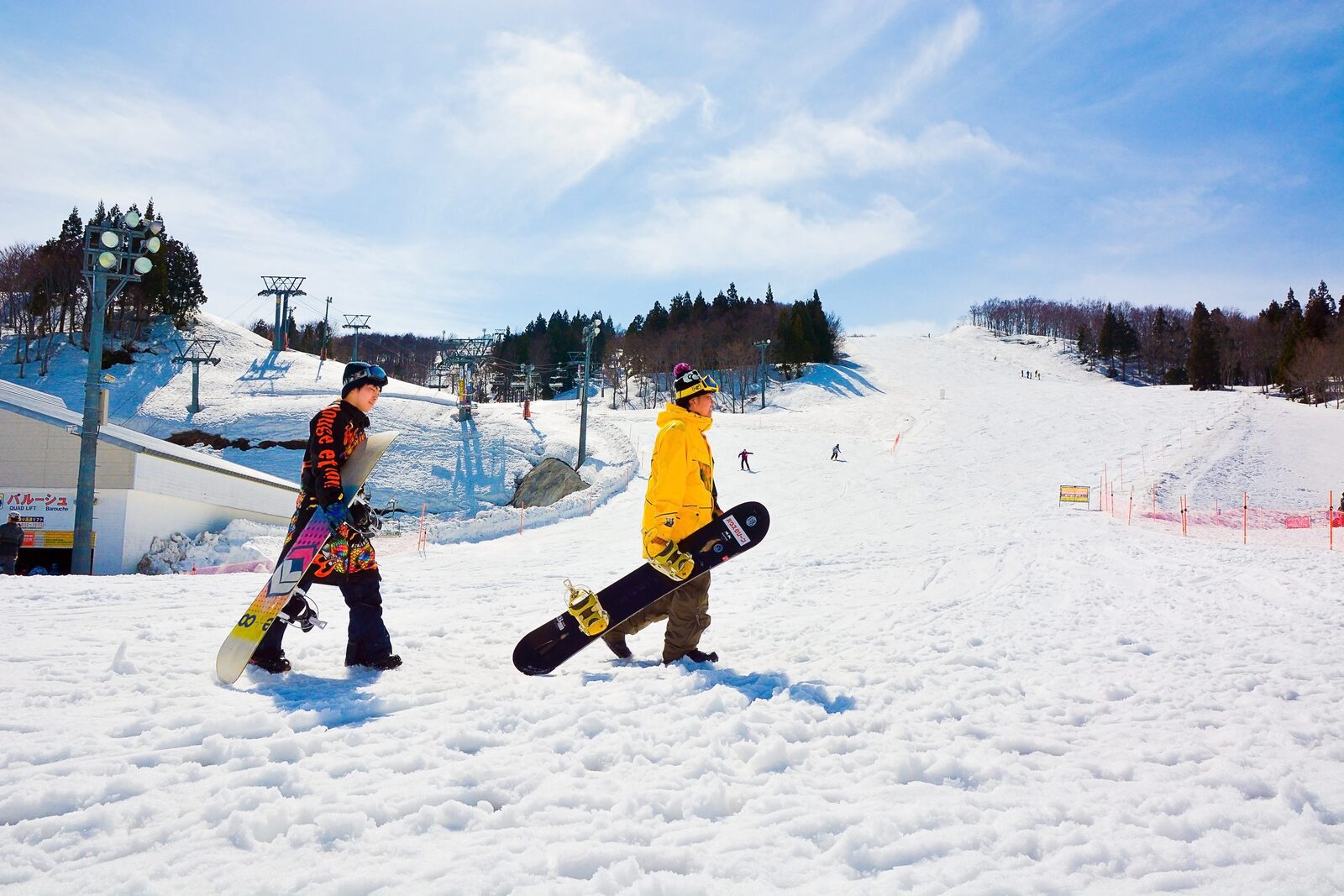 滑雪者背著雪板走向 GALA 湯澤雪道