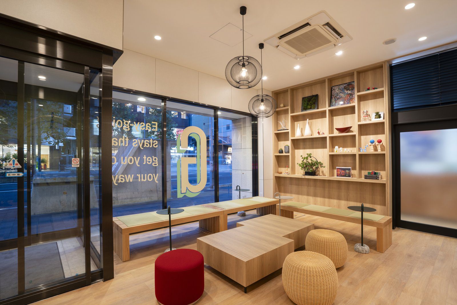 Garner Hotel 京都四條烏丸 玻璃門旁的大廳休息區與木製展示架