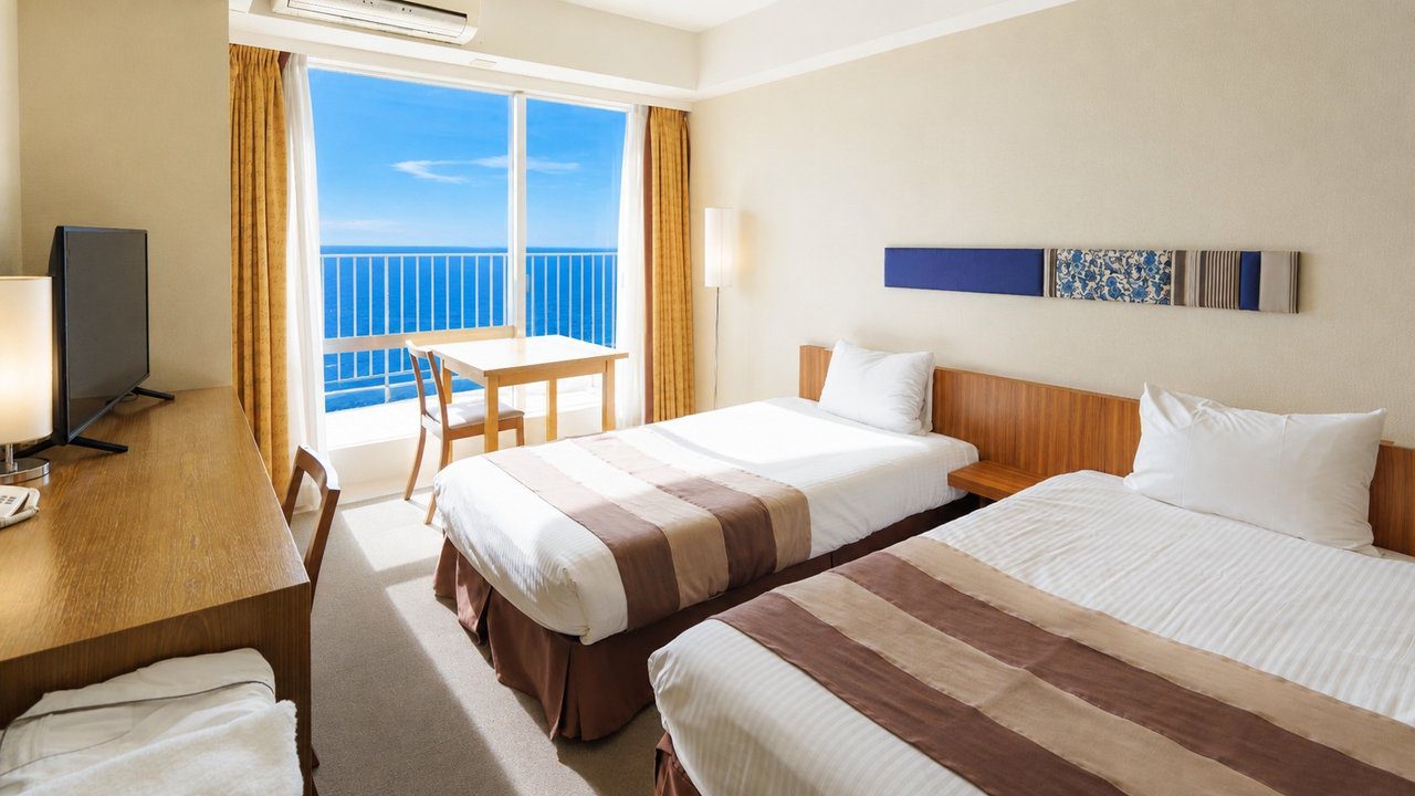 The Beach Tower 沖繩 精巧雙床房的兩張床與窗外海景